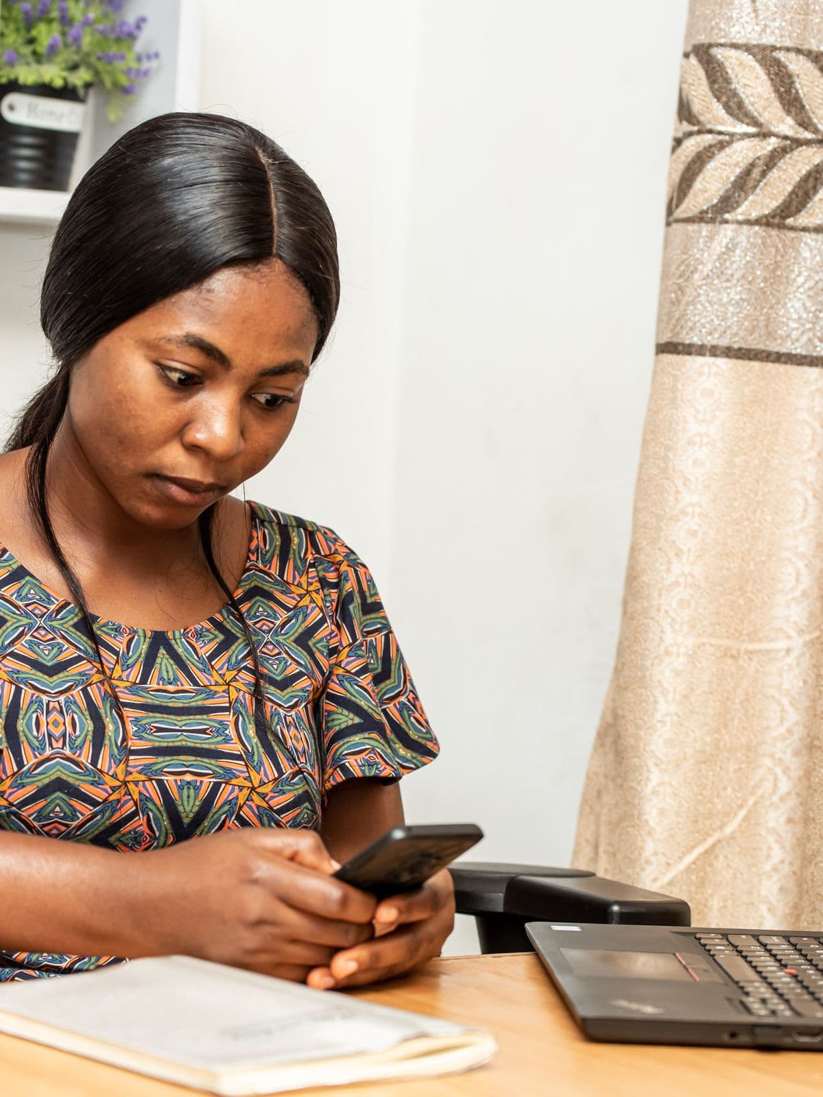 A woman at home comparing gas prices on her phone